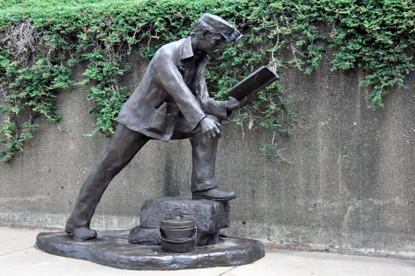 man and book sculpture